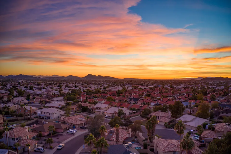 Drone view of colorful sunset over suburban neighborhood in Phoenix, Arizona